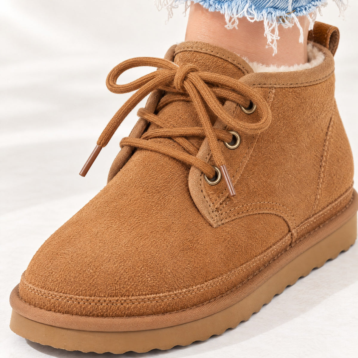 Rounded suede toe and lace-up front of the Clementine ankle boot