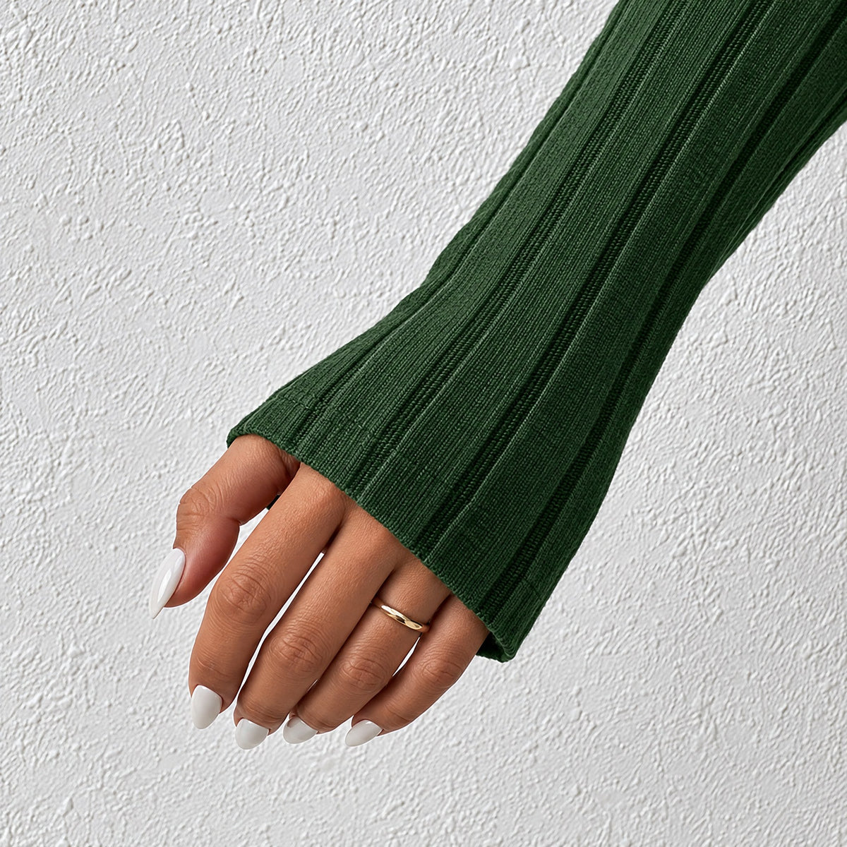 Long ribbed sleeve of the Gemma mini dress in green, reaching over the back of the hand