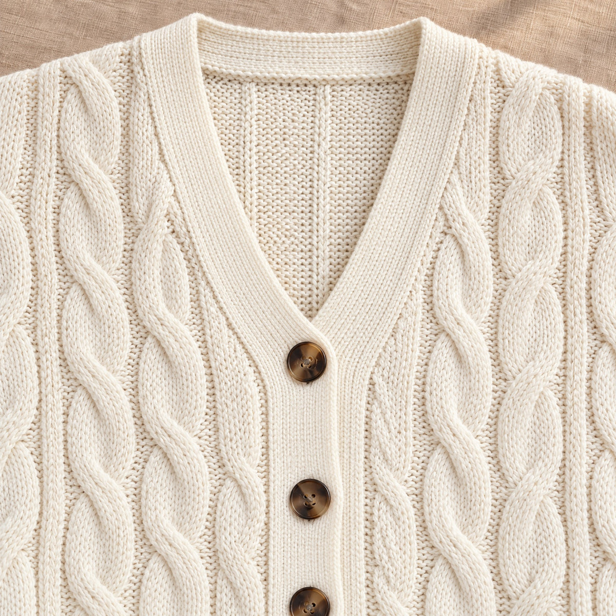 V-neckline, ribbed band and buttons of the Valentina cardigan