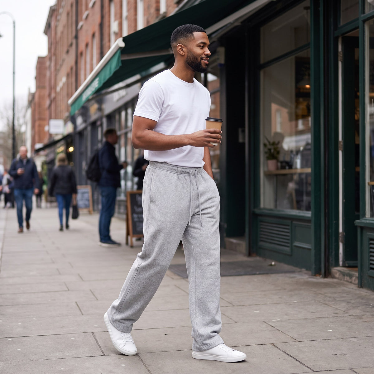 Man wearing the Alberto wide-leg sweatpants in Heather Gray on a city sidewalk