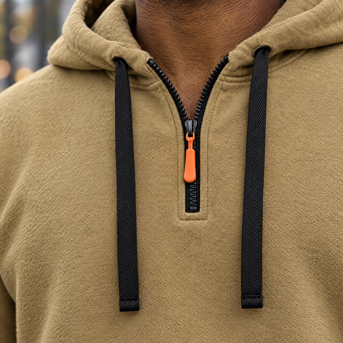 Leandro hoodie quarter zipper with orange pull and drawstrings, close-up