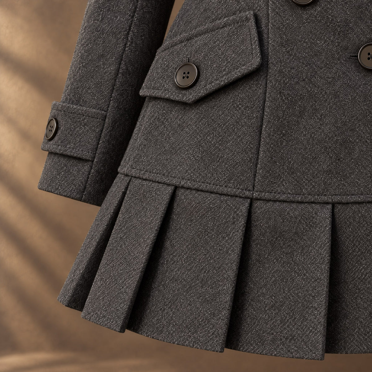 Pleated hem and flap pocket of the Morgana coat